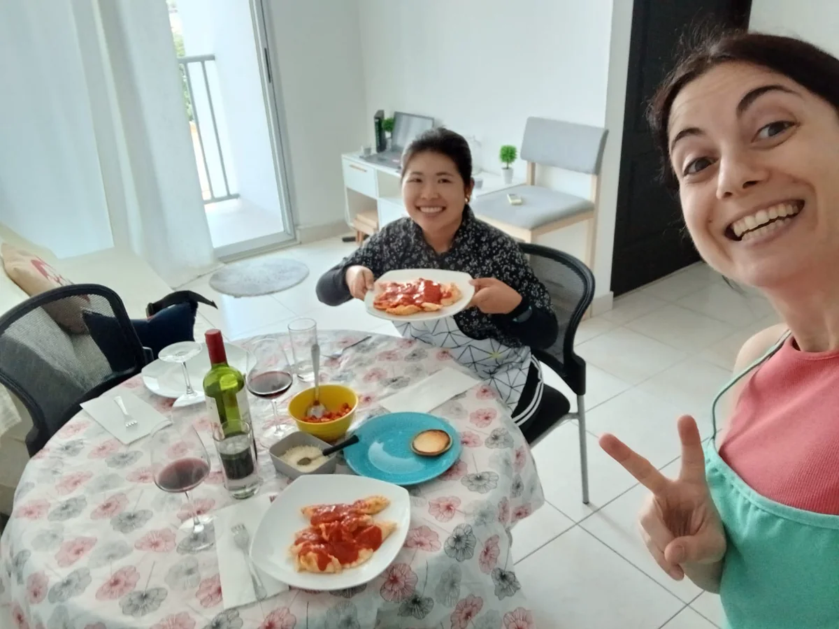 Guests eating handmade pasta with Luciana at the table